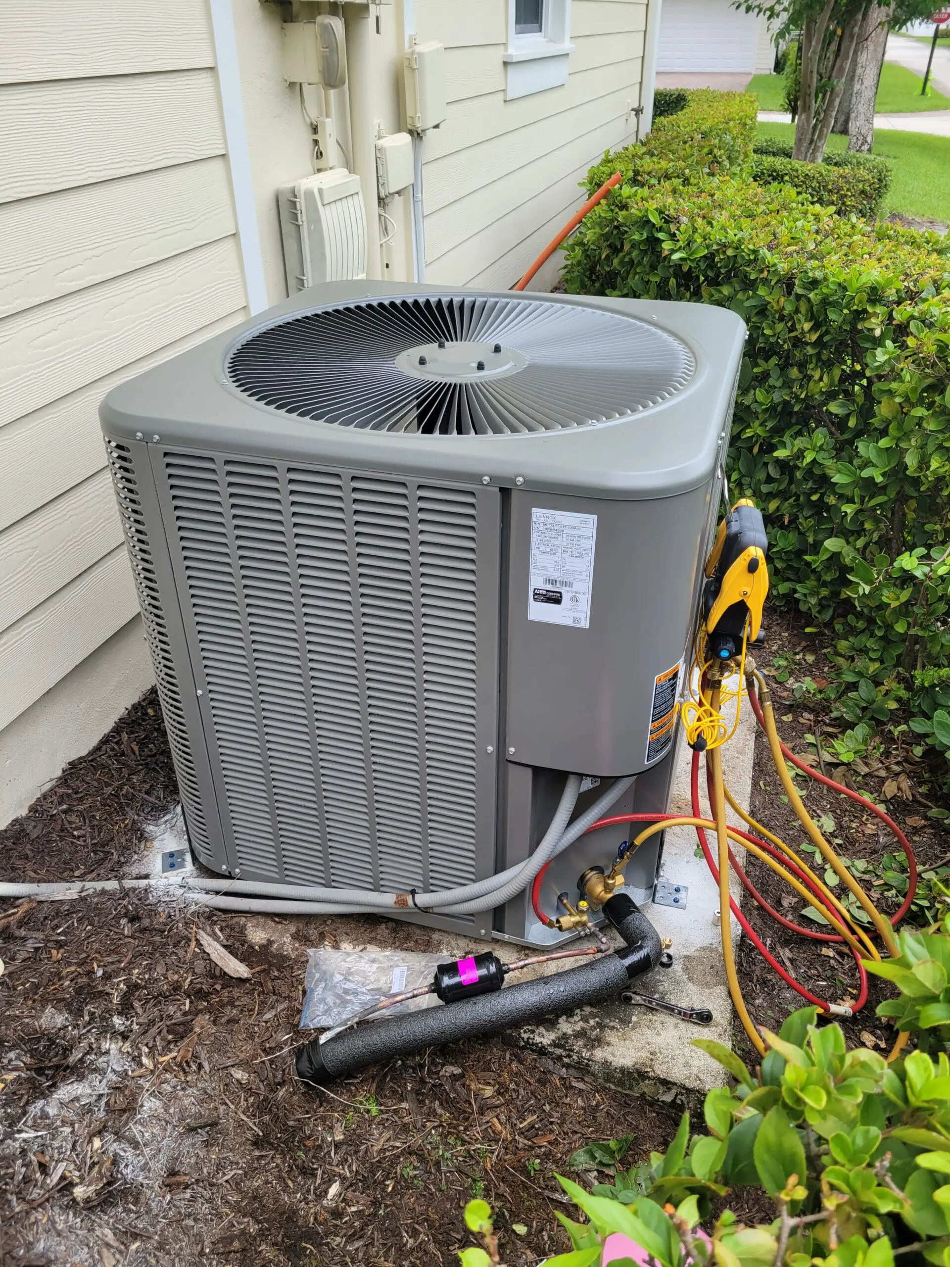 Outdoor AC condenser with a buzzing AC compressor serviced by Elsmar Air in Boca Raton