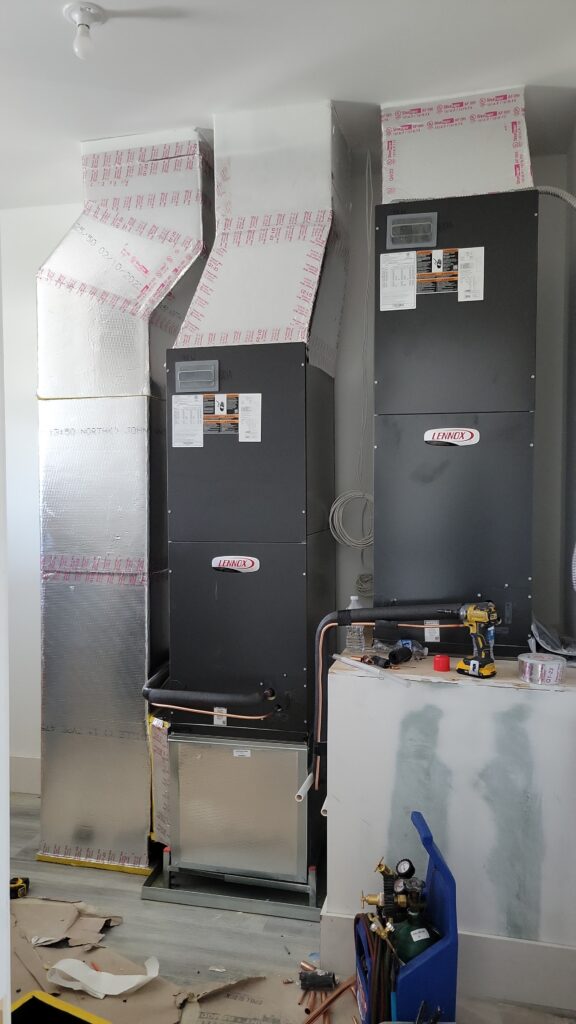 Two indoor air handlers connected to new ductwork during installation