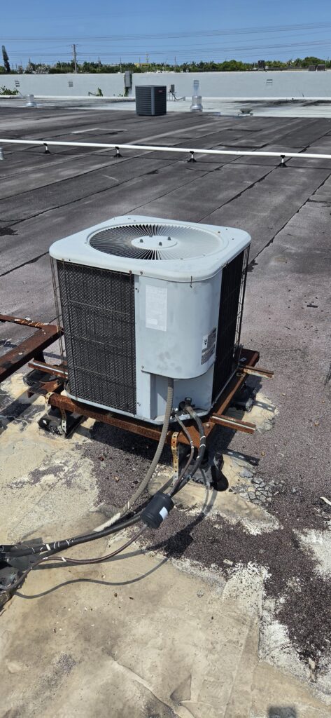 Elsmar Air technician helping a Davie homeowner decide to repair or replace their AC