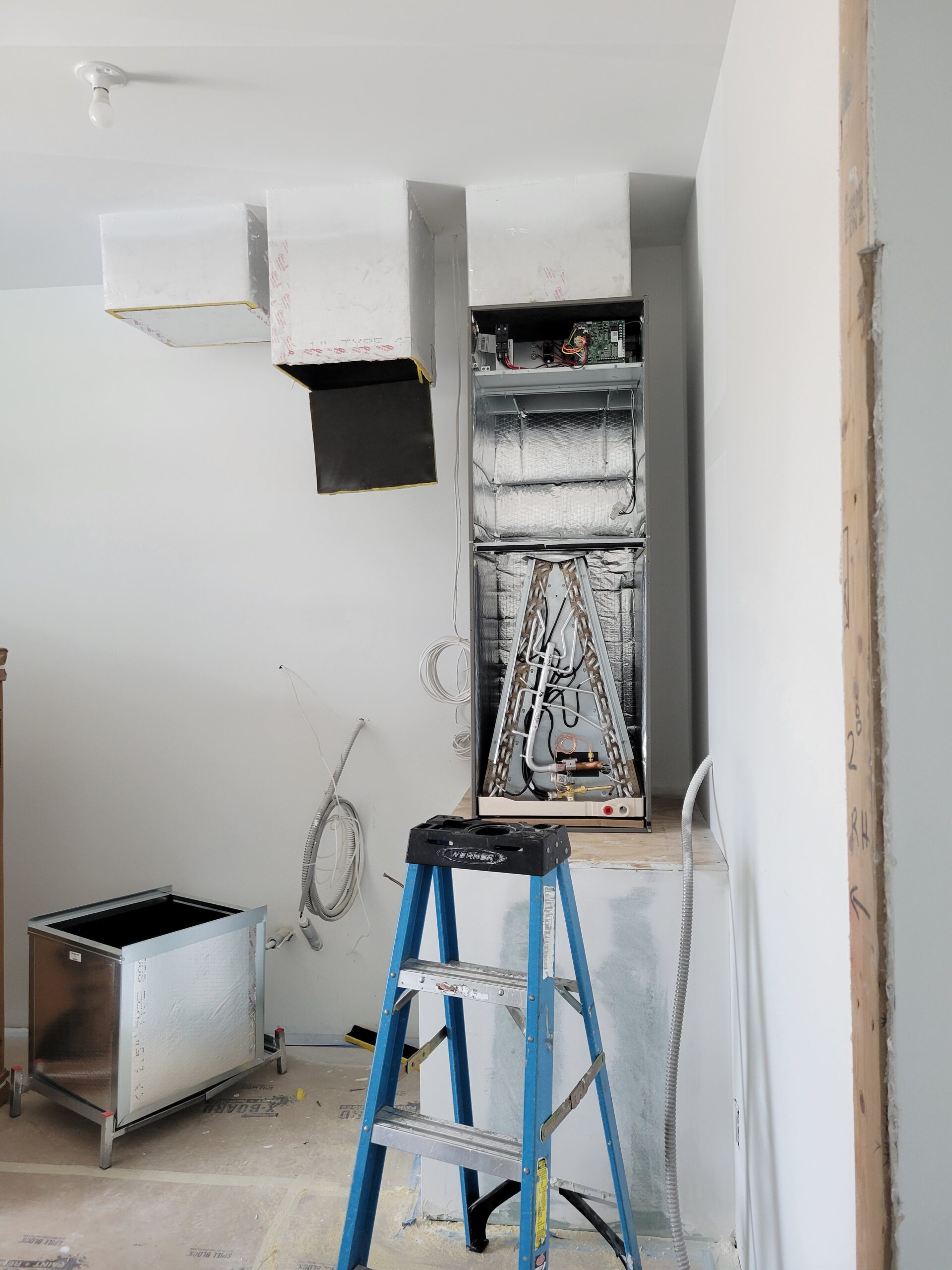 Air handler being installed with new duct connections